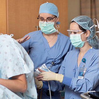 Anesthesiology residents working with a patient.