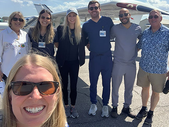 Internal Medicine residents posing for a group photo in front of an aircraft during their four-week Aerospace Medicine elective.