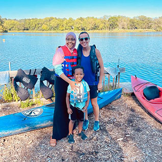 ENT resident and family on a beach next to a lake