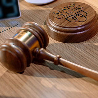 Gavel laying on a desk to represent the Juris Doctor (J.D.) dual degree option at Mayo Clinic Alix School of Medicine.